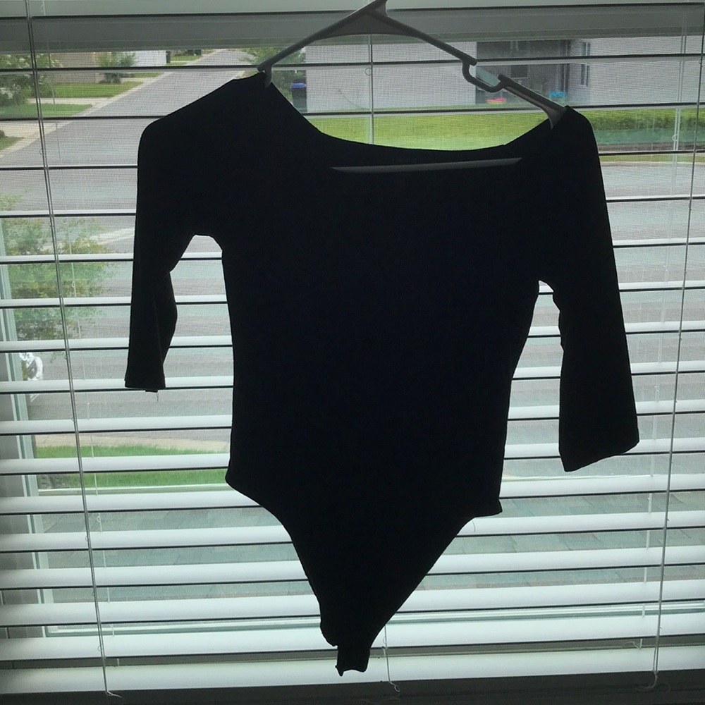 Small, black body suit. Off the shoulders.